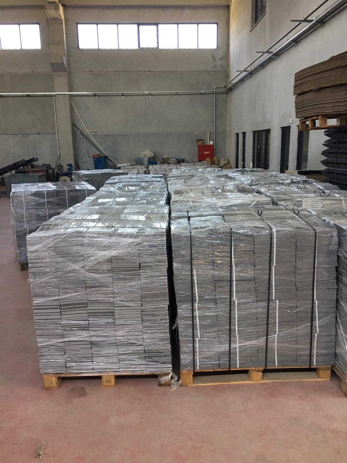 Pallets of cover plates waiting for dispatch in the factory warehouse