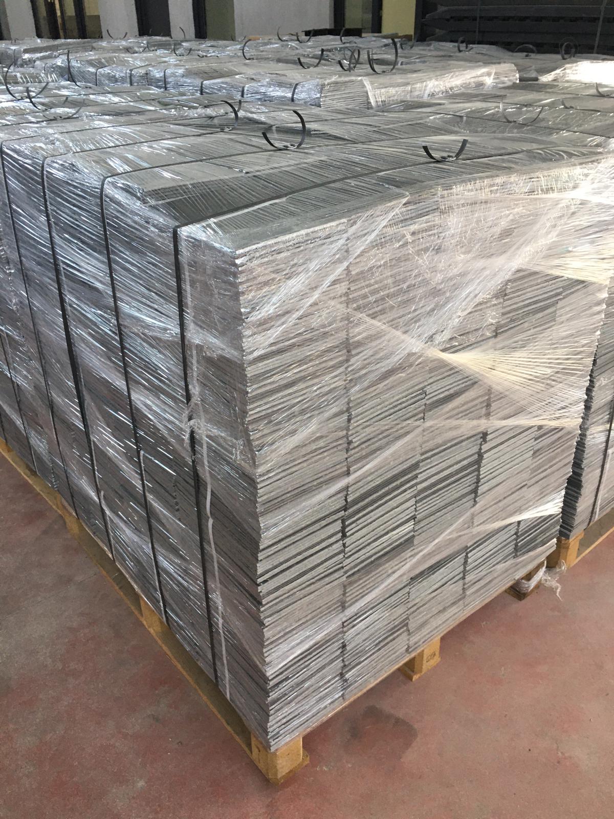 Close view of a shrink-wrapped and strapped pallet of cover plates