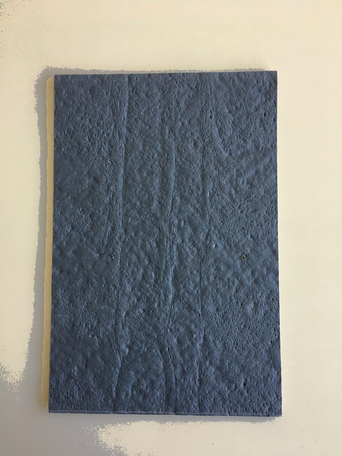A single cable cover plate with a textured anthracite surface